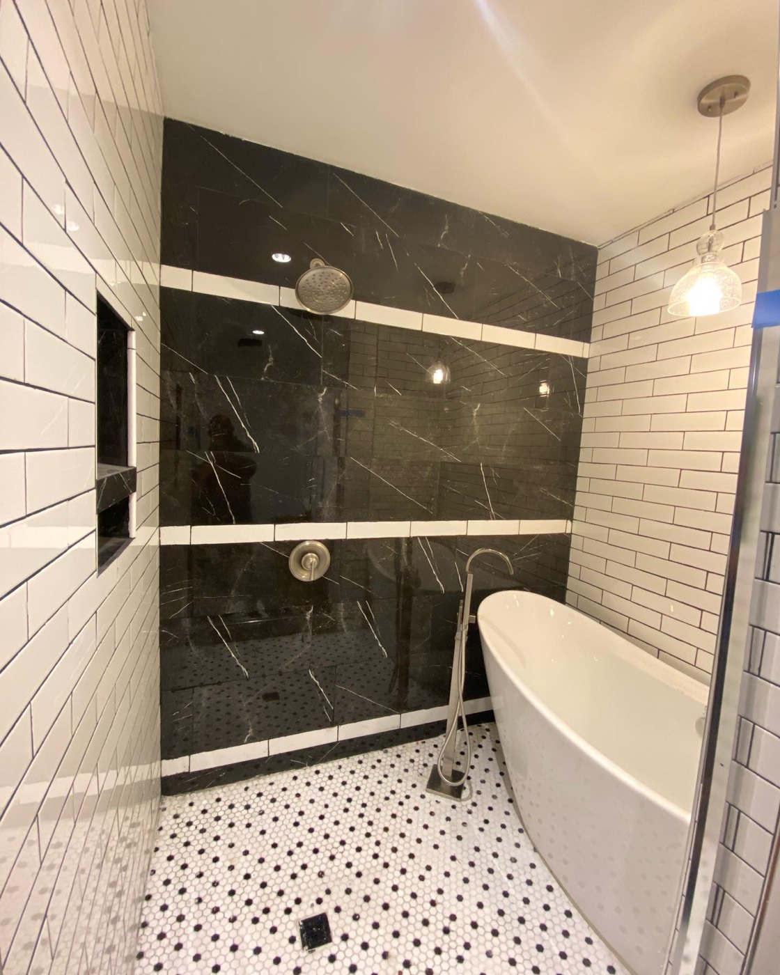 Black marble and subway tile bathroom remodel